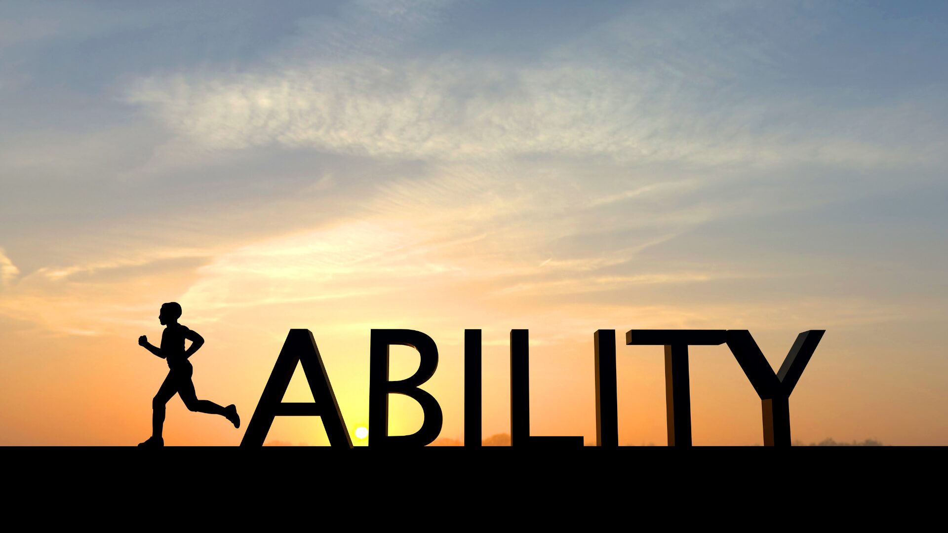 ABILITYの文字の向こう側に夕日がさしている