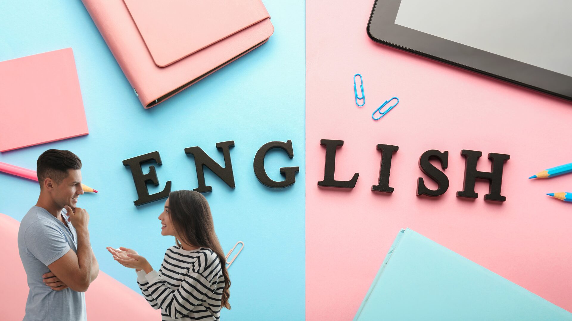 男性と女性が「ENGLISH」と書かれた看板の前で会話をしている